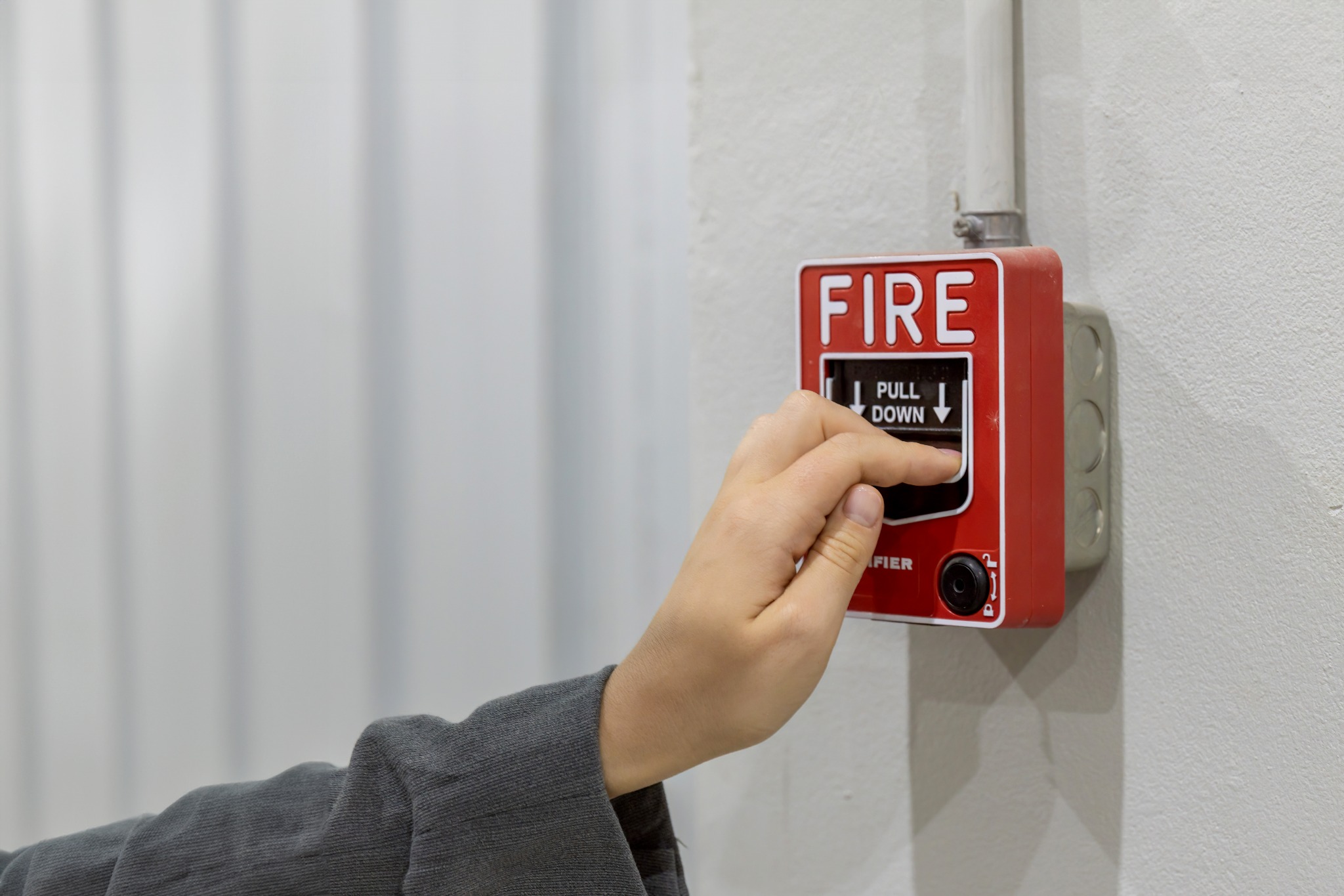 Fire alarm pull station on wall